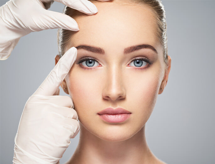 Stock image of female model doctor checking eyebrows