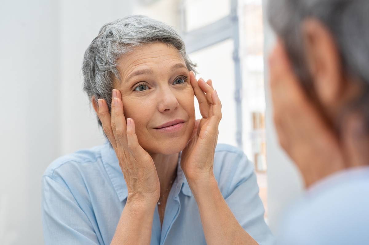 concept of woman checking how skin ages around the eyes