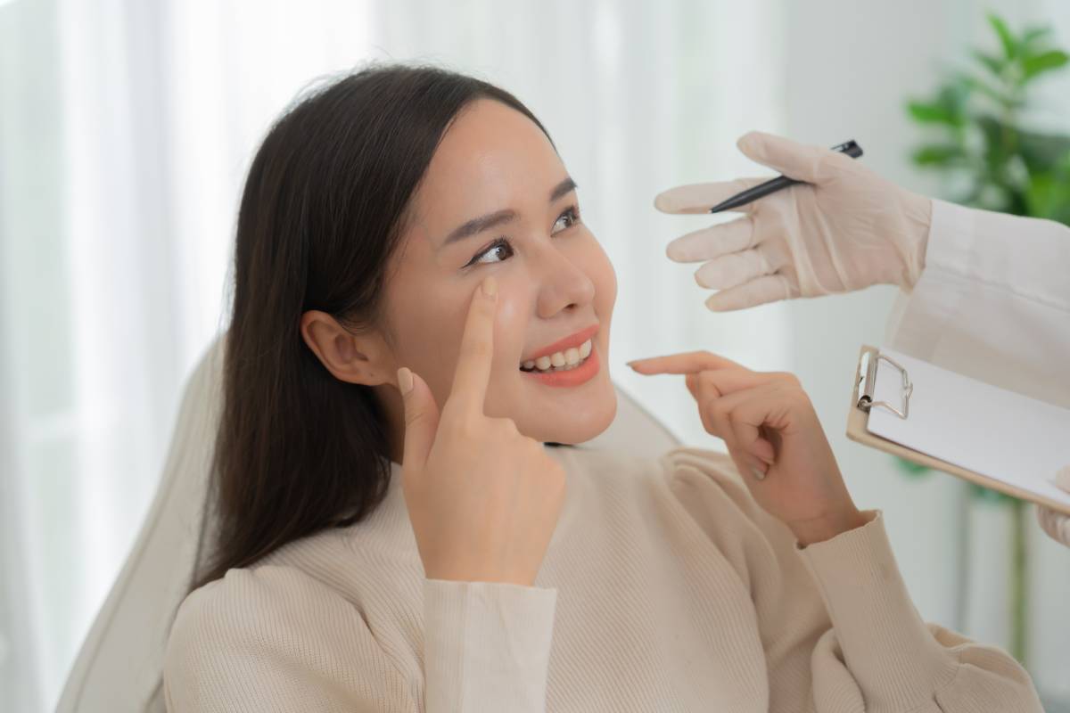 Woman receiving consultation for cosmetic procedure.